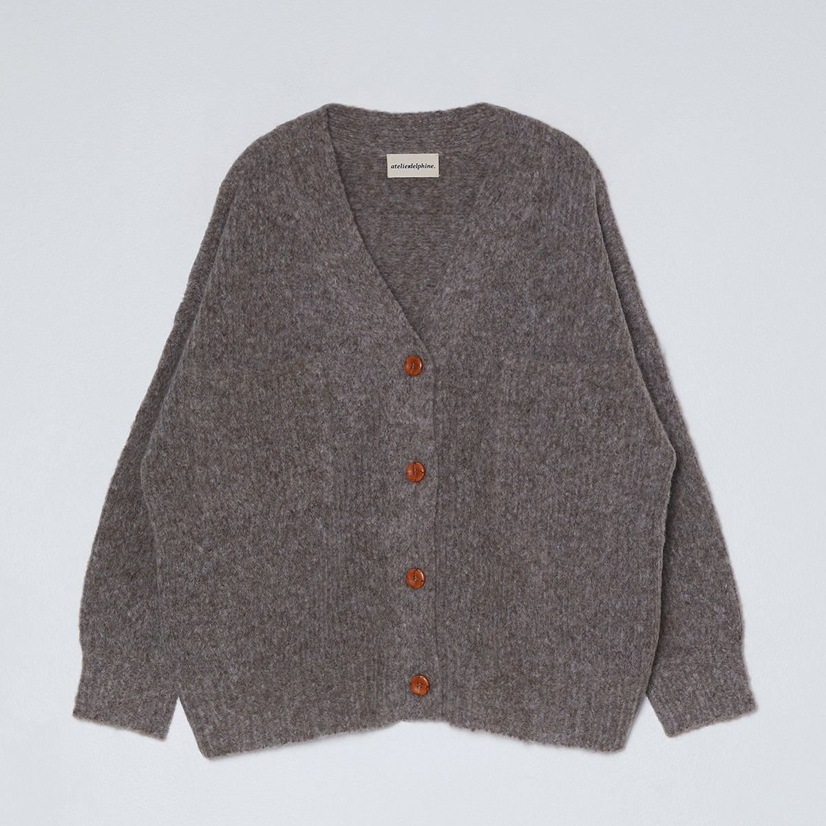 Gray cardigan with red buttons on a light gray background